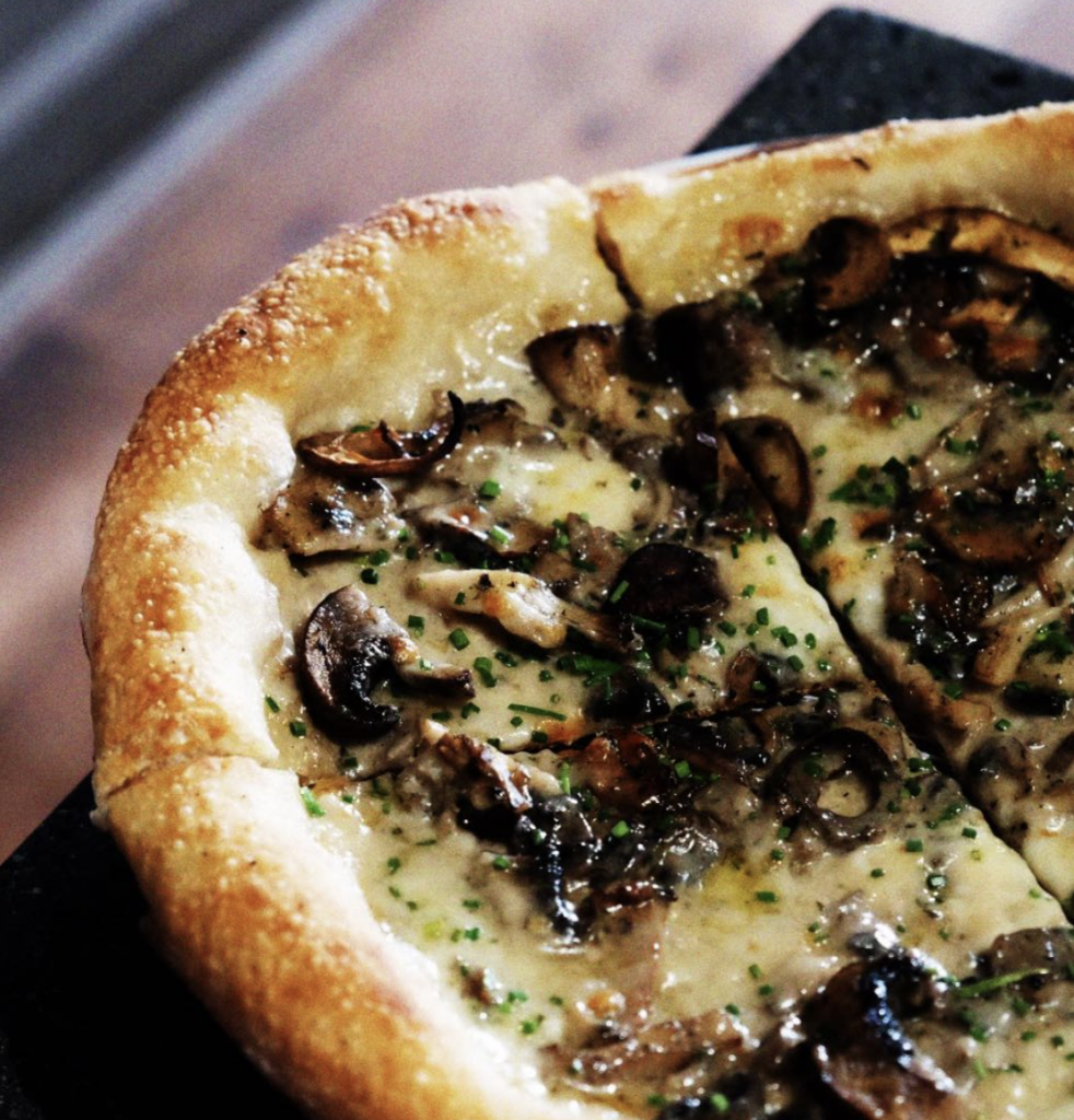 Mushroom pizza with white sauce, fresh from the oven.